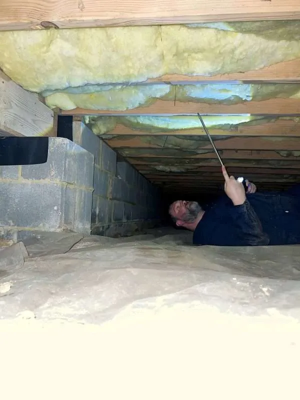 Evan inspecting a home crawlspace during a residential pest control visit in Newport News